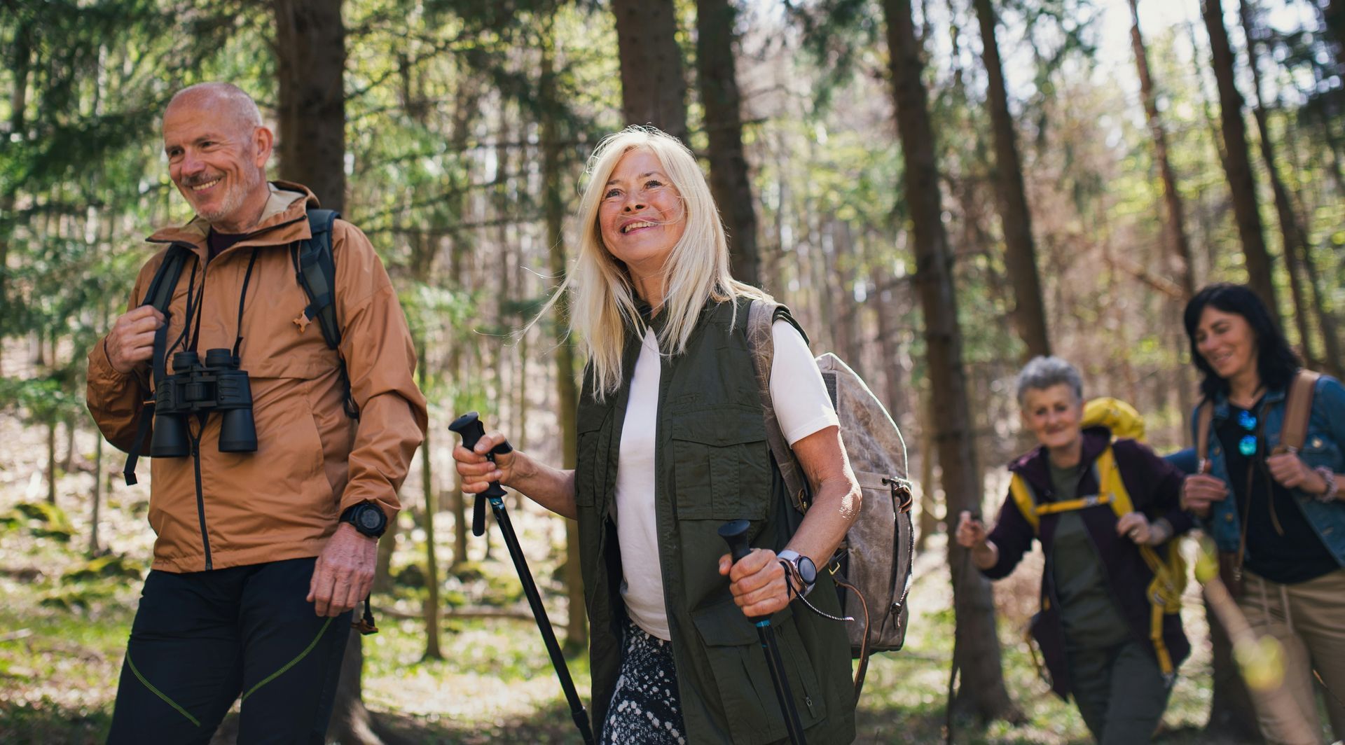A group of people are hiking in the woods.
