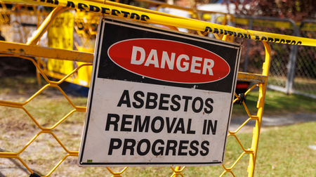 A danger sign that says asbestos removal in progress