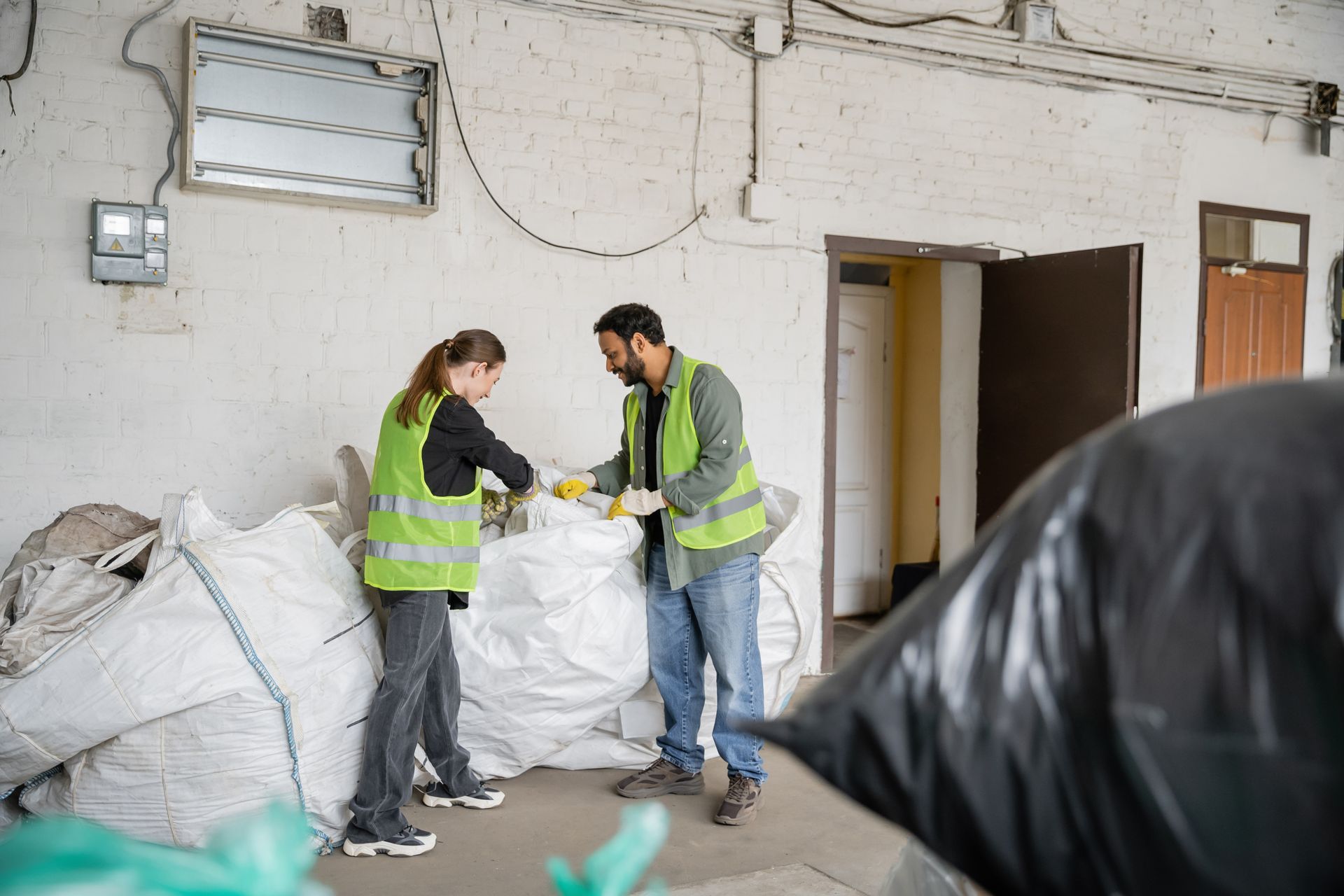 A man and a woman are standing next to each other in a warehouse.