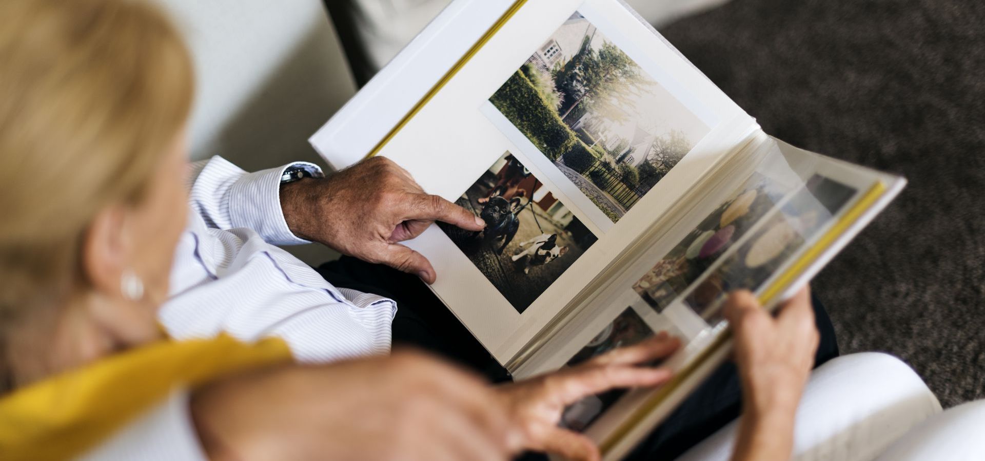 A man and a woman are looking at a photo album