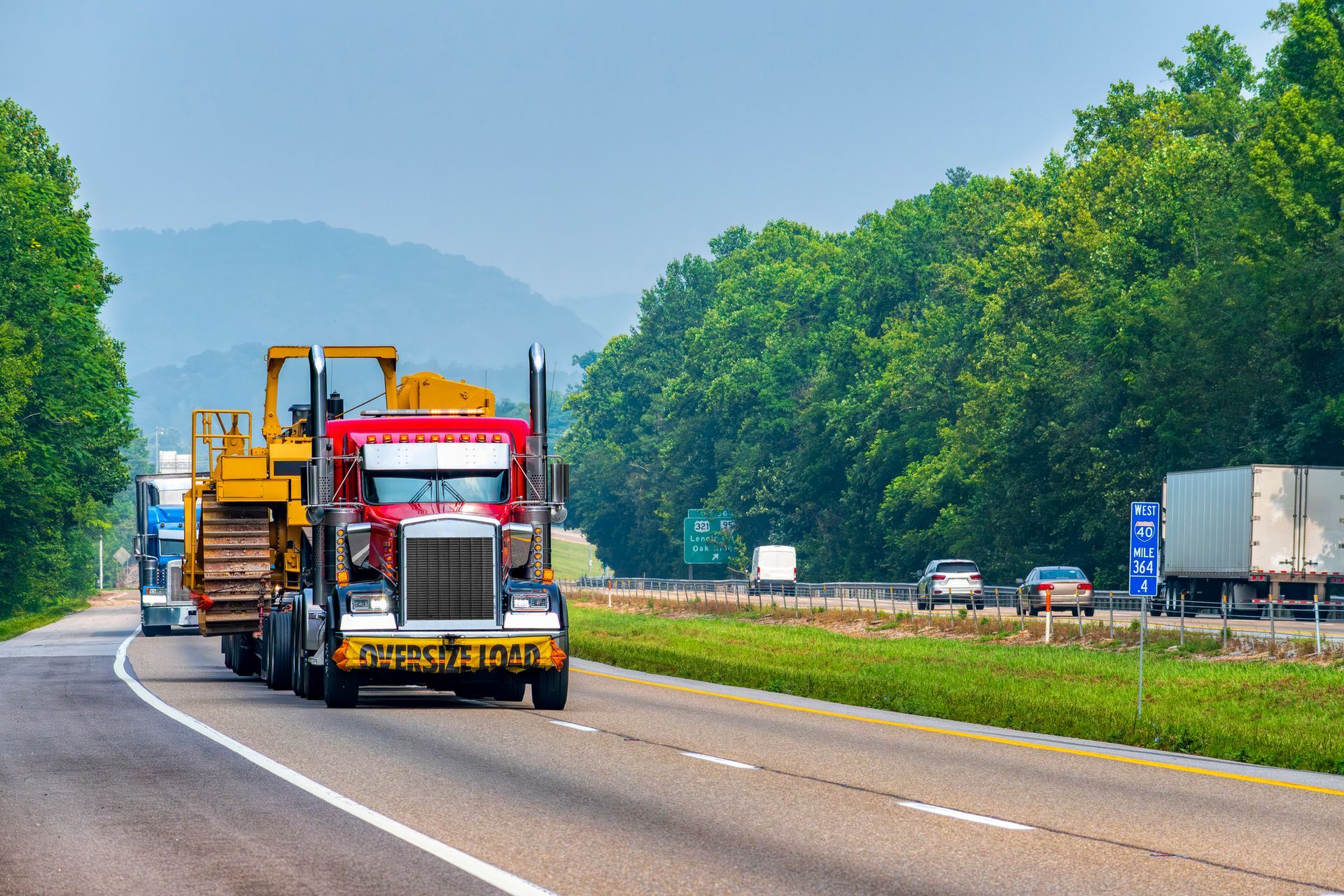 Heavy machinery being transported on highway.