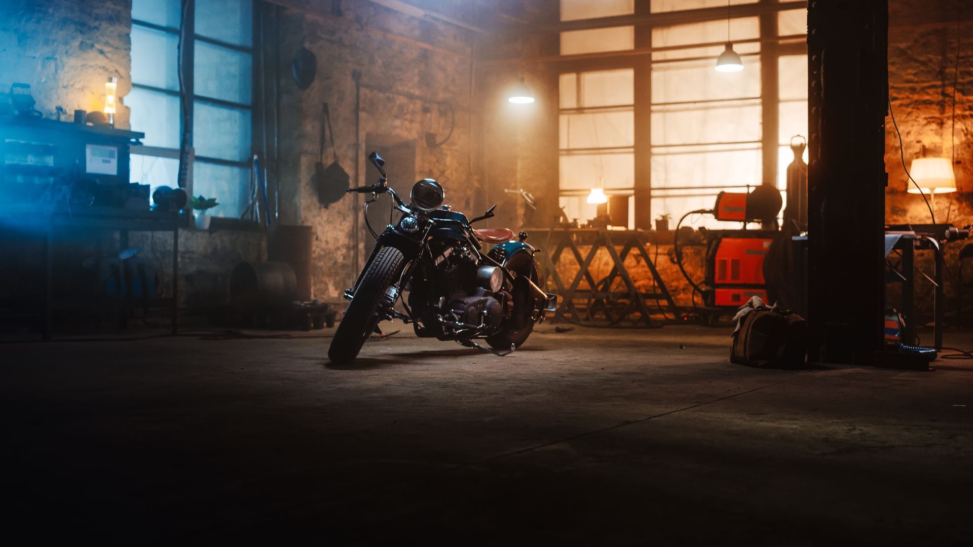 A motorcycle is parked in a dark garage.