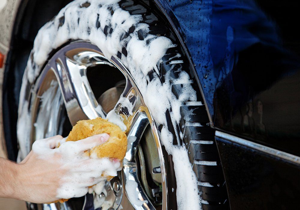 Person Cleaning The Car Wheels — Hutchinson, MN — Sullivan Mobile Detailing