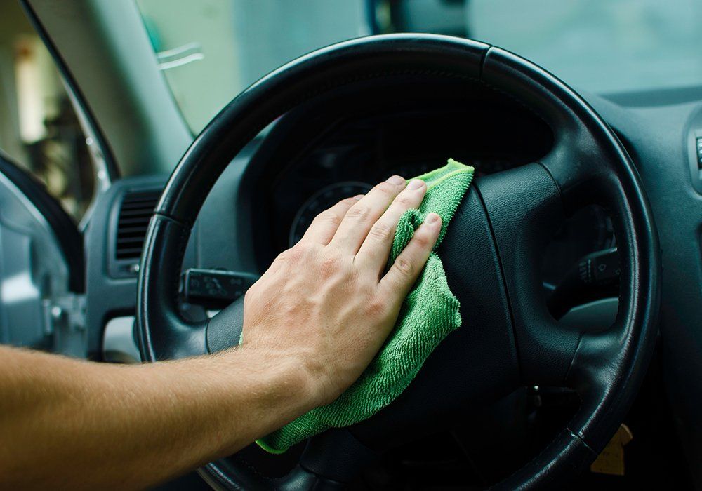 Person Cleaning The Steering Wheel — Hutchinson, MN — Sullivan Mobile Detailing