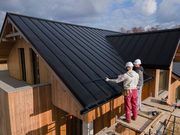 Dark gray tiled roof with a vertical ridge, viewed from above.
