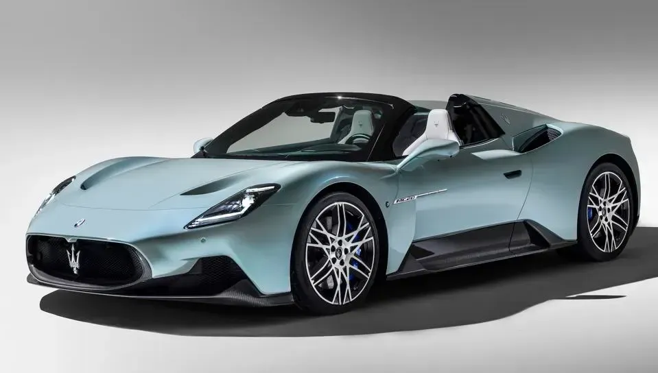 A blue sports car is parked on a white surface.