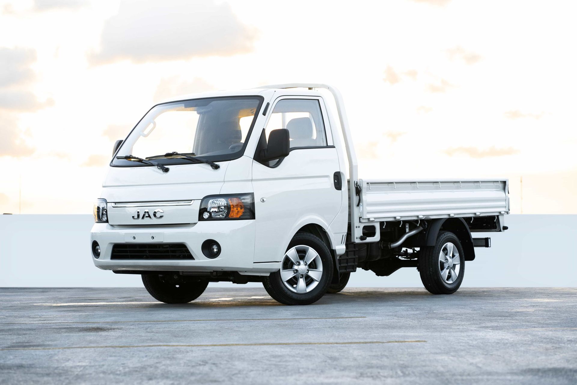 A white truck is parked in a parking lot.