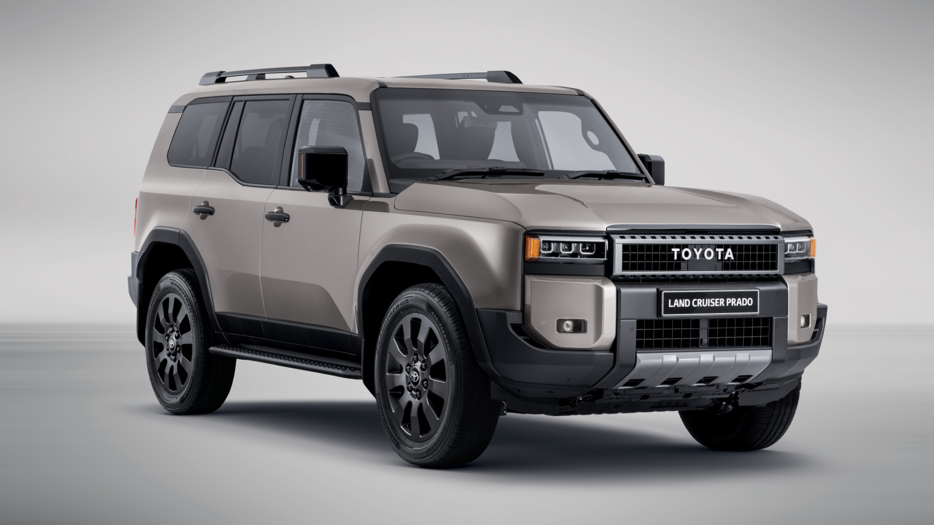 A toyota land cruiser is sitting on top of a white surface.