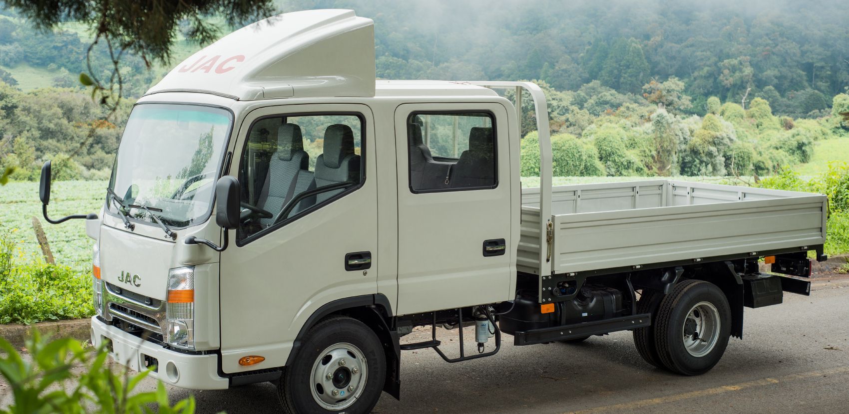 A white truck is parked on the side of the road.
