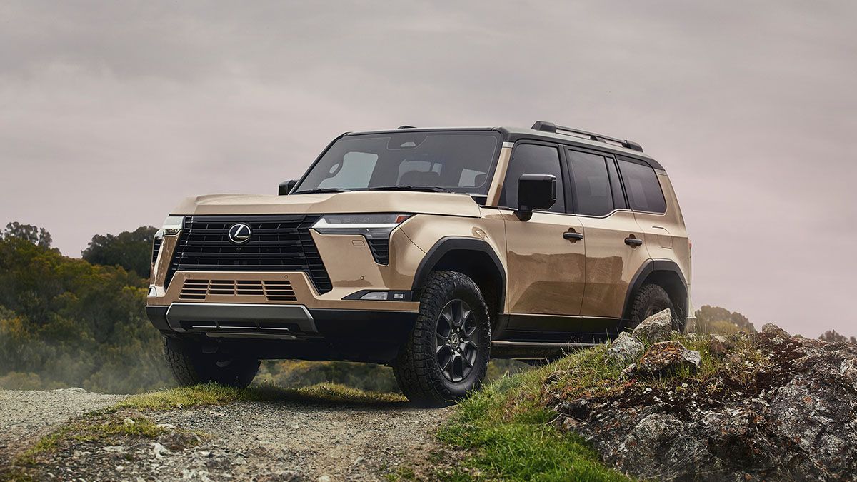 A toyota land cruiser is parked on top of a rocky hill.