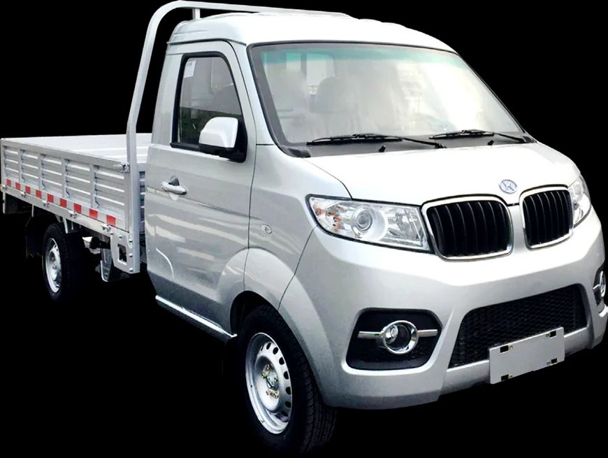 A small white truck with a flat bed is on a black background.