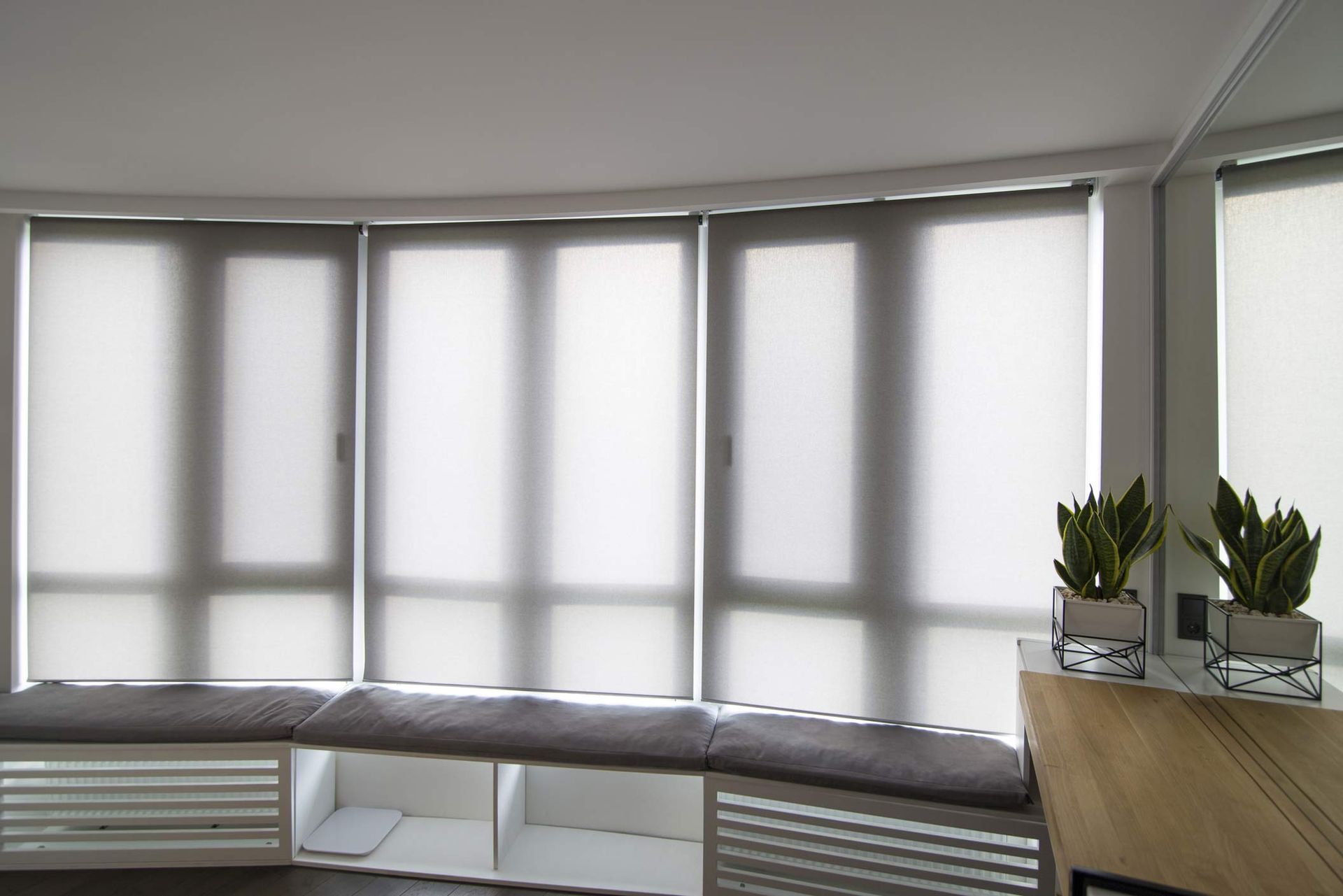 Modern room highlighting motorized window treatment featuring elegant roller blinds design.