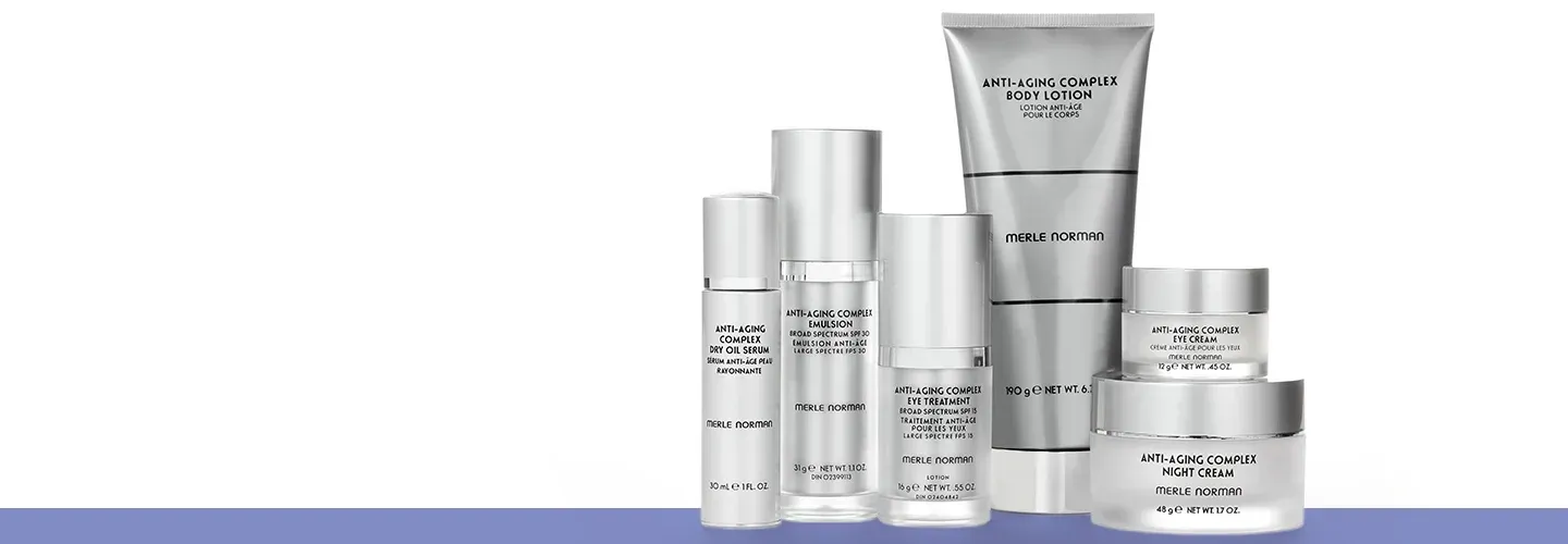 Silver skincare product lineup in bottles, tubes, and jars on a white background