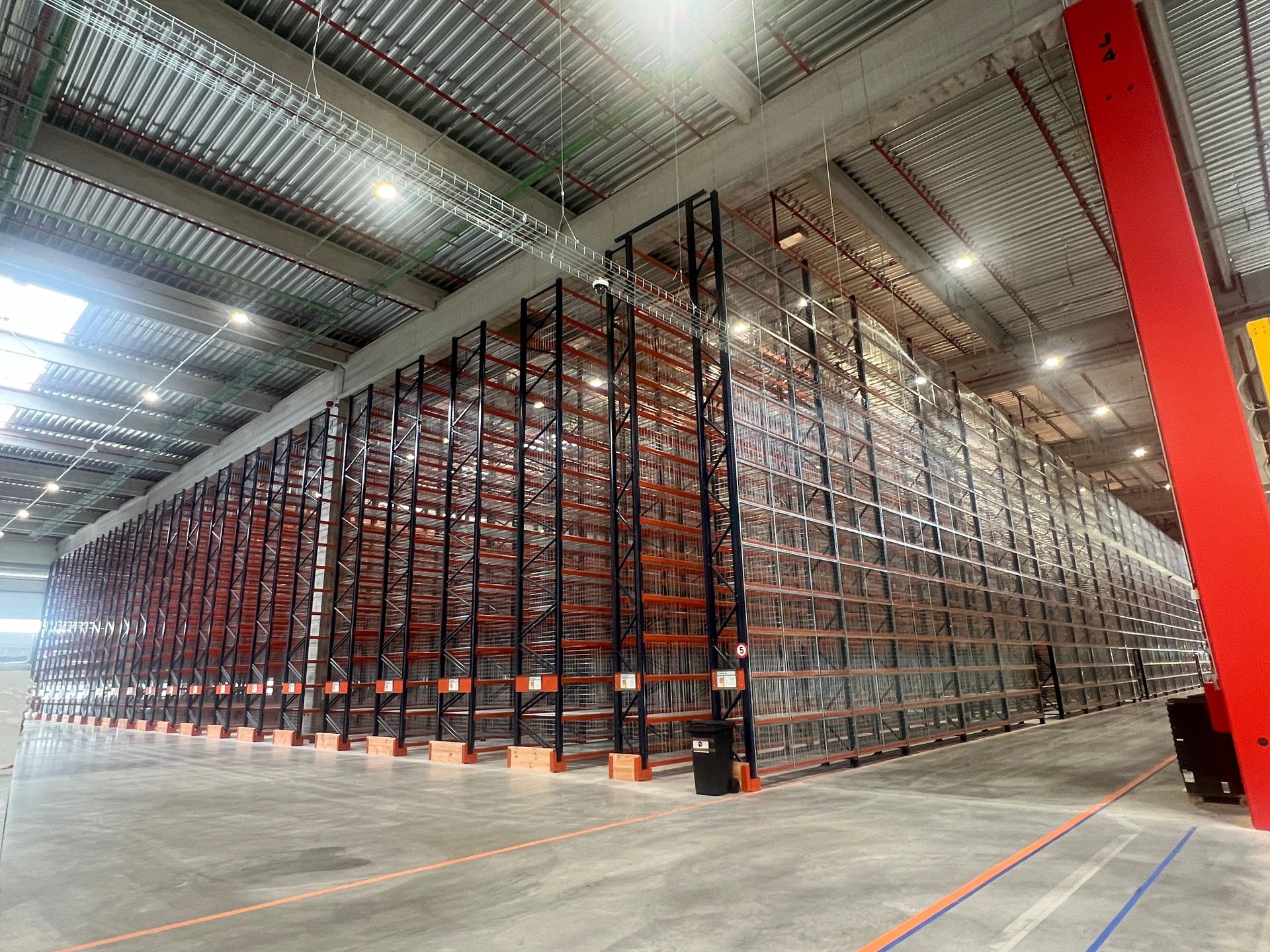 Un grande magazzino pieno di scaffali e pallet.