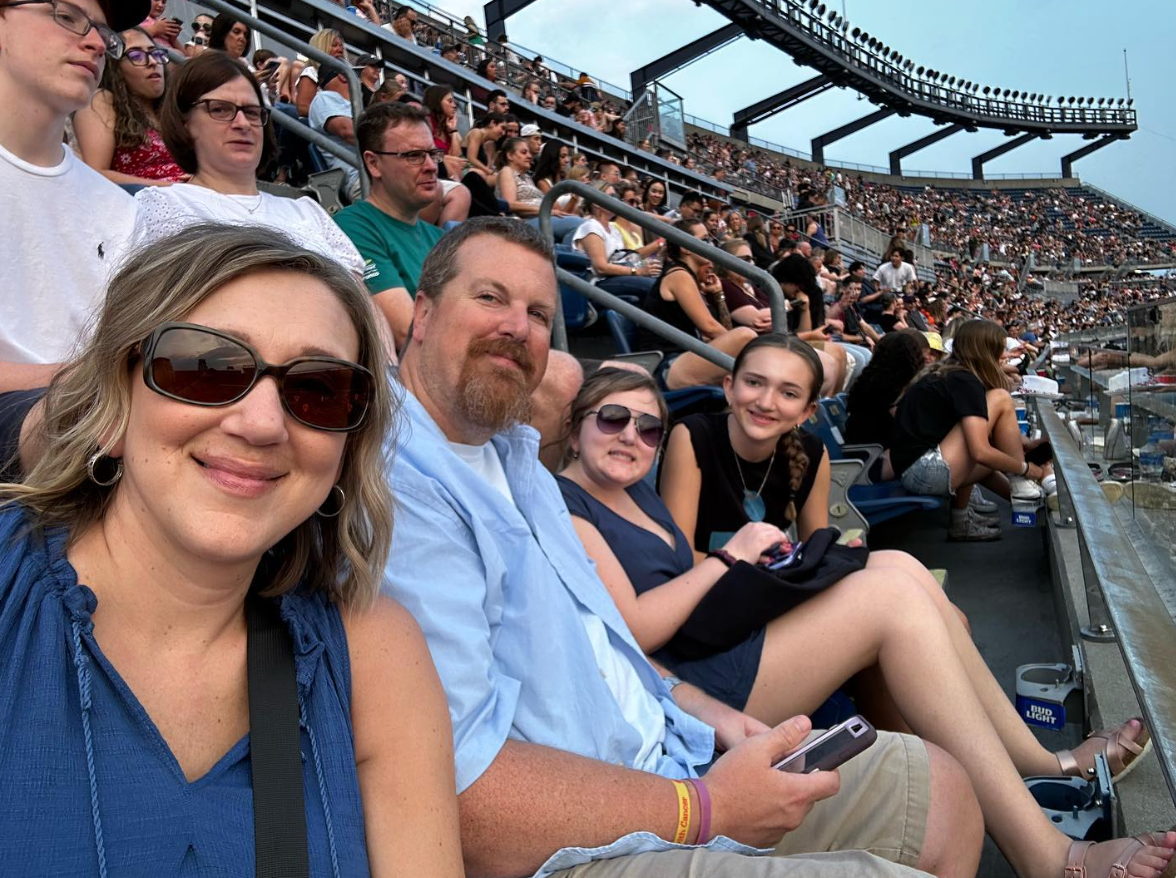 A group of people are sitting in a stadium watching a game.
