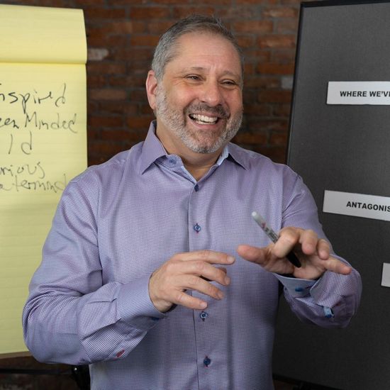 A man is smiling in front of a sign that says biogas americas