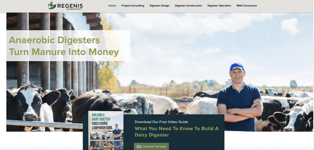 Aerial view of an industrial facility with large, dark, round storage tanks and adjacent green wastewater treatment ponds.