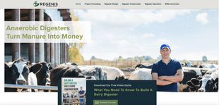 Aerial view of an industrial facility with large, dark, round storage tanks and adjacent green wastewater treatment ponds.