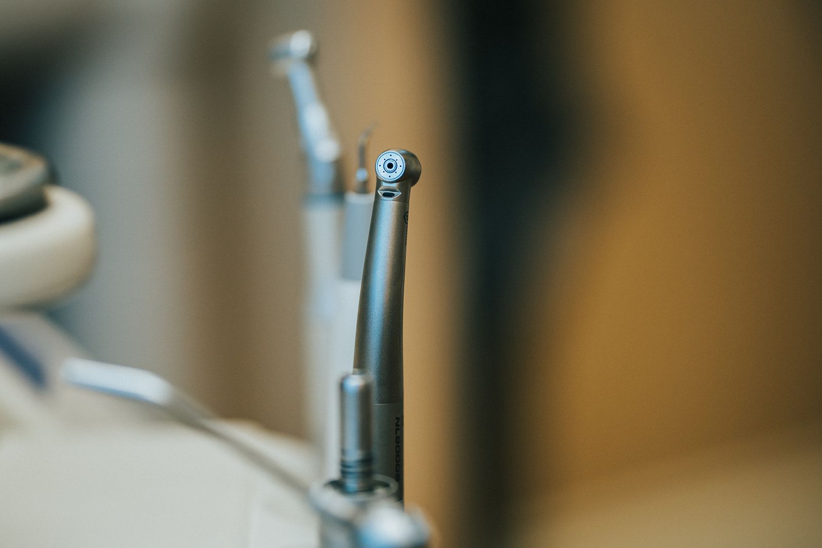 Person wearing gloves using a computer at a desk. Spray bottle and keyboard visible.