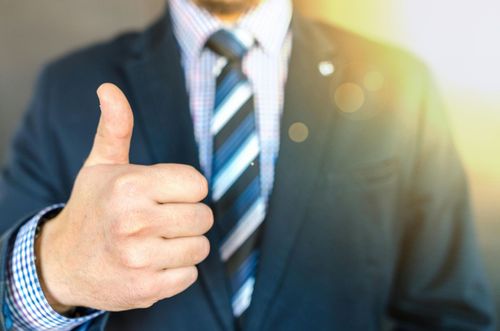 Thumbs up man with tie and suit