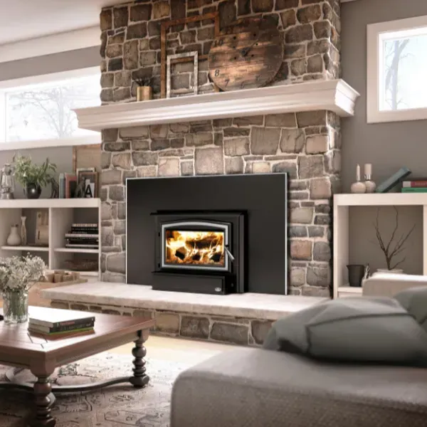 Stone fireplace with a burning fire, gray hearth, and walls.