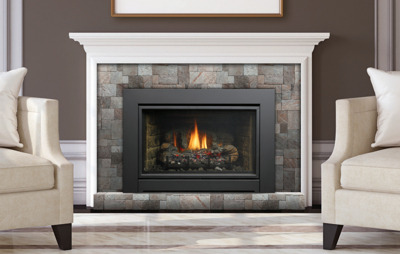 Fireplace with flames, black frame, gray stone tile surround, white mantel, and two armchairs.