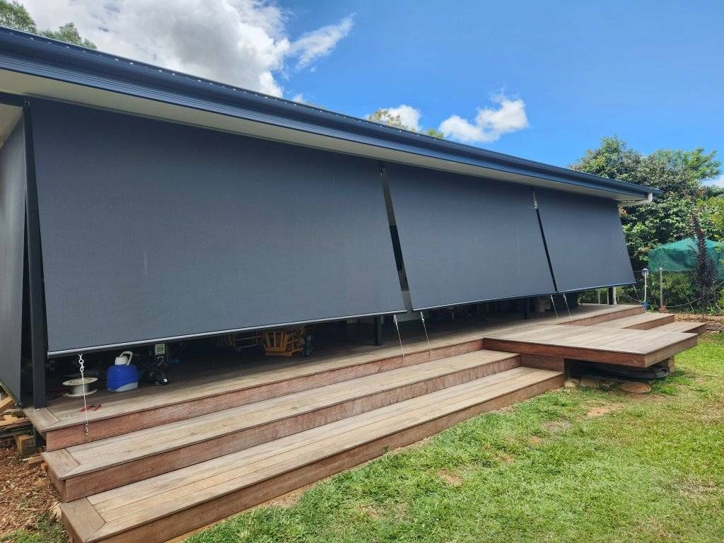 House With a Deck and Stairs and a Gray Awning on the Side of It — Tropical Shade Blinds in Tablelands, QLD