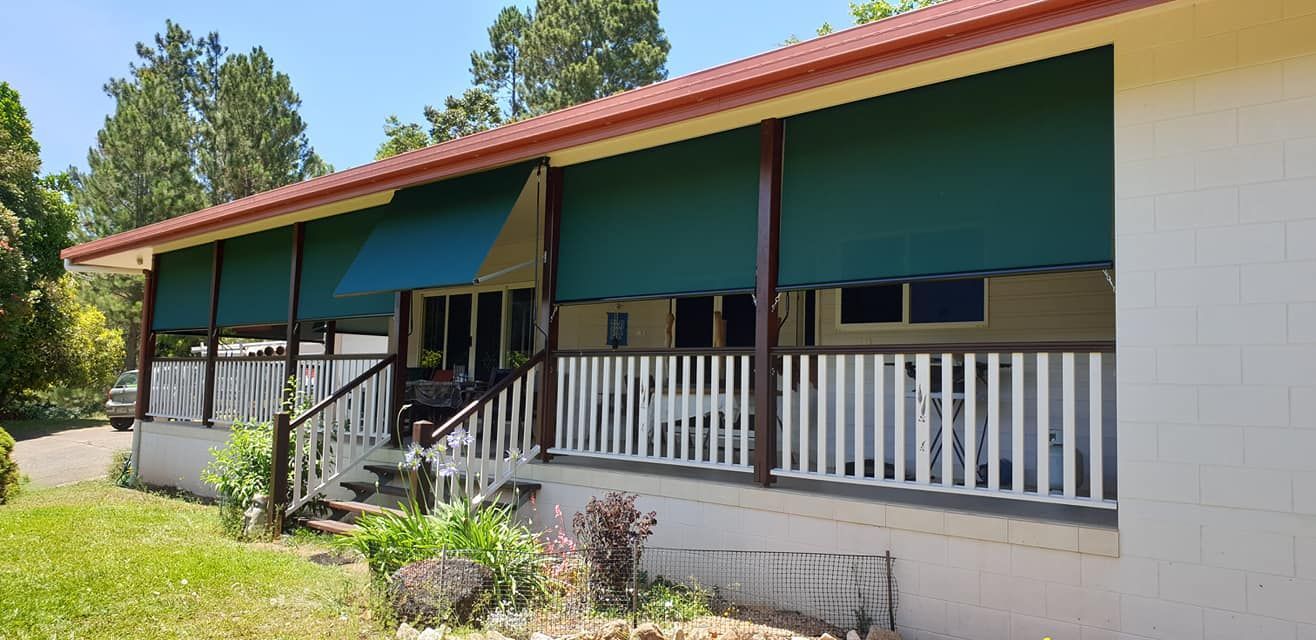 White House With a Green Awning on the Porch — Tropical Shade Blinds in Brinsmead, QLD