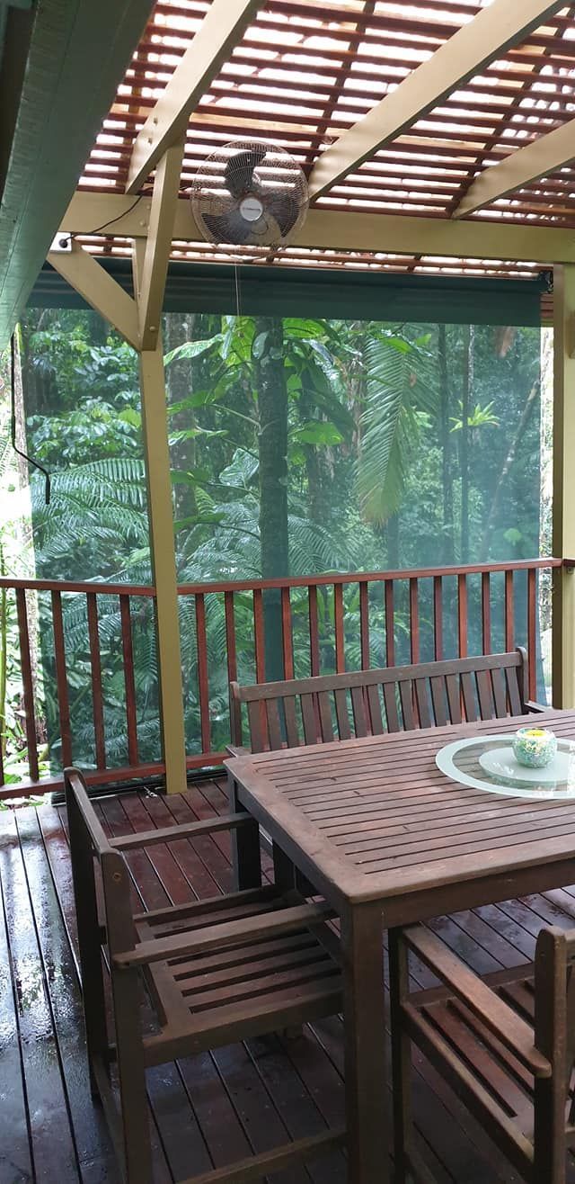 Wooden Deck With a Table and Chairs and a Ceiling Fan — Tropical Shade Blinds in Port Douglas, QLD