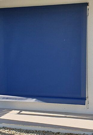 Blue Blind is Hanging on a White Wall — Tropical Shade Blinds in Brinsmead, QLD