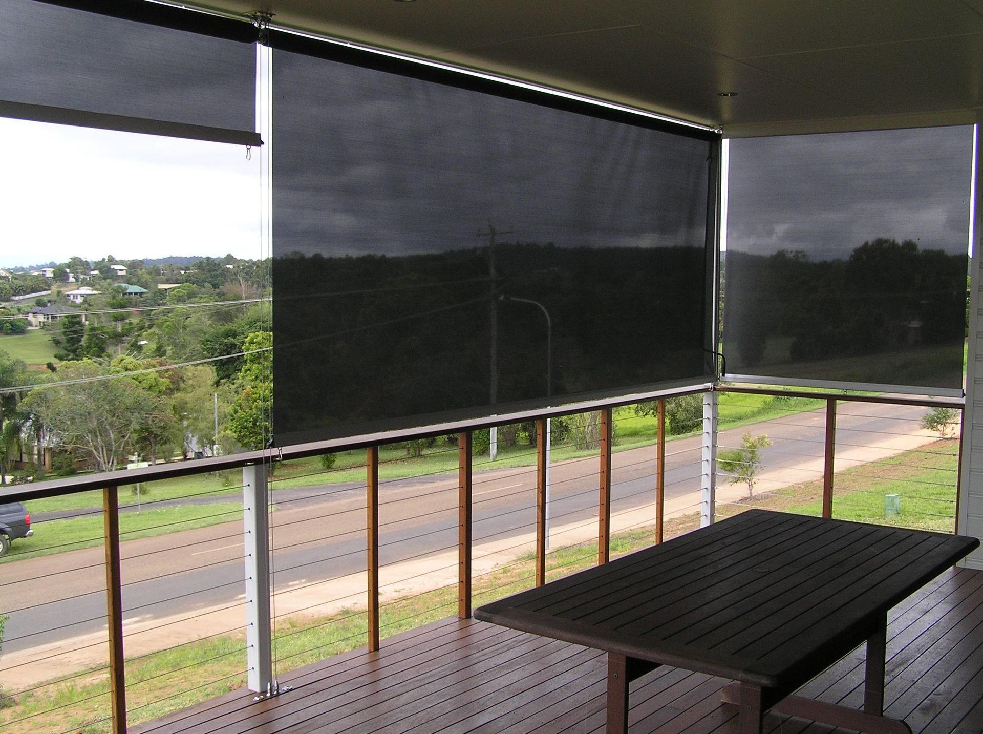 Close Up of a Wire Guide With Trees Behind It — Tropical Shade Blinds in Brinsmead, QLD