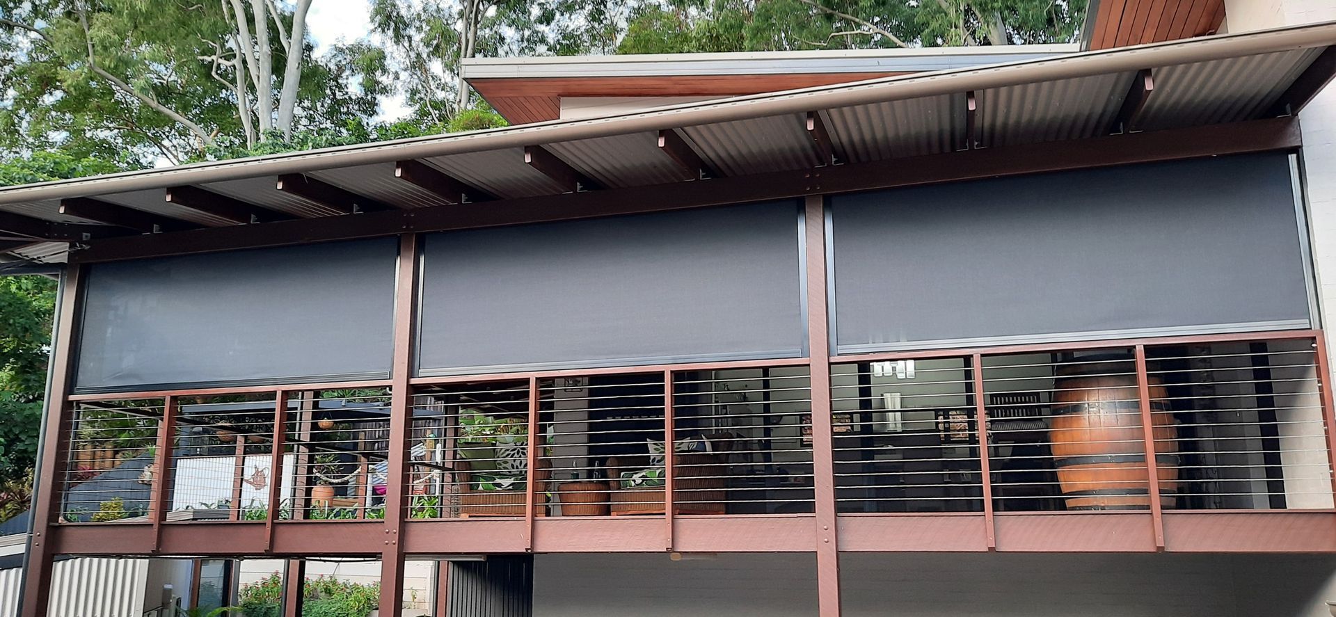A Black Zip Screen With A Brown Frame — Tropical Shade Blinds in Brinsmead, QLD
