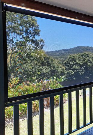 Balcony With a View of a Lush Green Field and Trees — Tropical Shade Blinds in Brinsmead, QLD