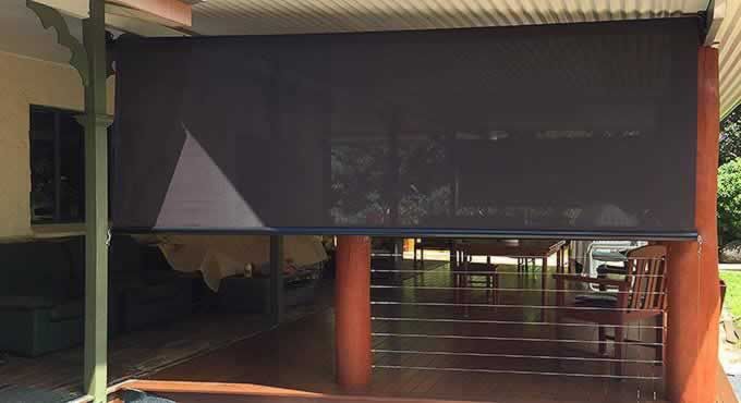 Black Awning is Covering a Porch of a House — Tropical Shade Blinds in Brinsmead, QLD