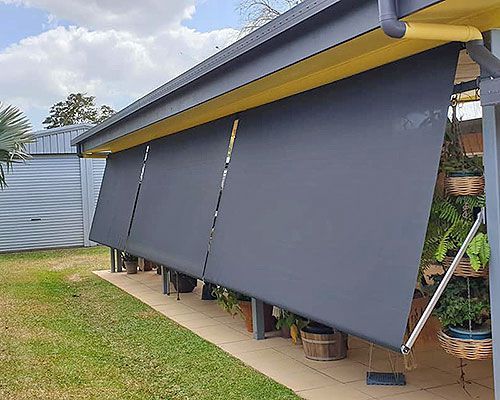 Black Awning is Hanging From the Side of a House — Tropical Shade Blinds in Brinsmead, QLD
