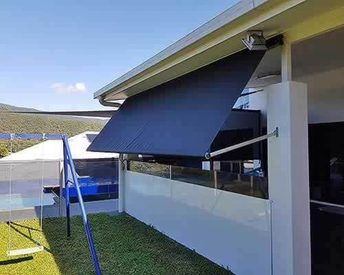Black Awning is Hanging From the Side of a House — Tropical Shade Blinds in Brinsmead, QLD