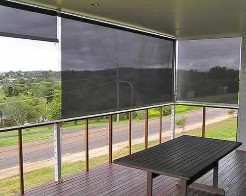 There is a Table on the Balcony With a View of the Countryside — Tropical Shade Blinds in Brinsmead, QLD