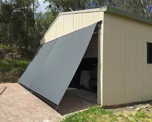 Garage Door With a Gray Awning on It is Open — Tropical Shade Blinds in Brinsmead, QLD