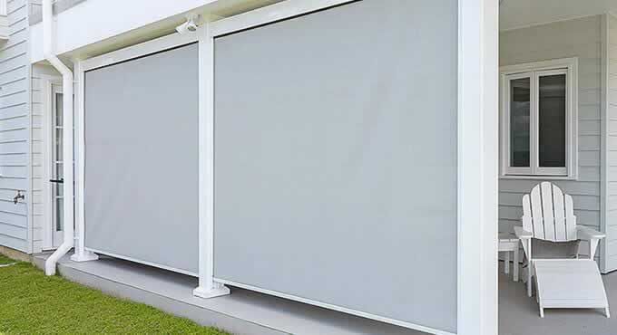 White House With a Porch With a Chair and a Table — Tropical Shade Blinds in Brinsmead, QLD