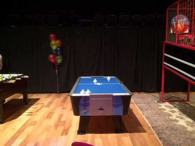 Professional air hockey in a game room theme