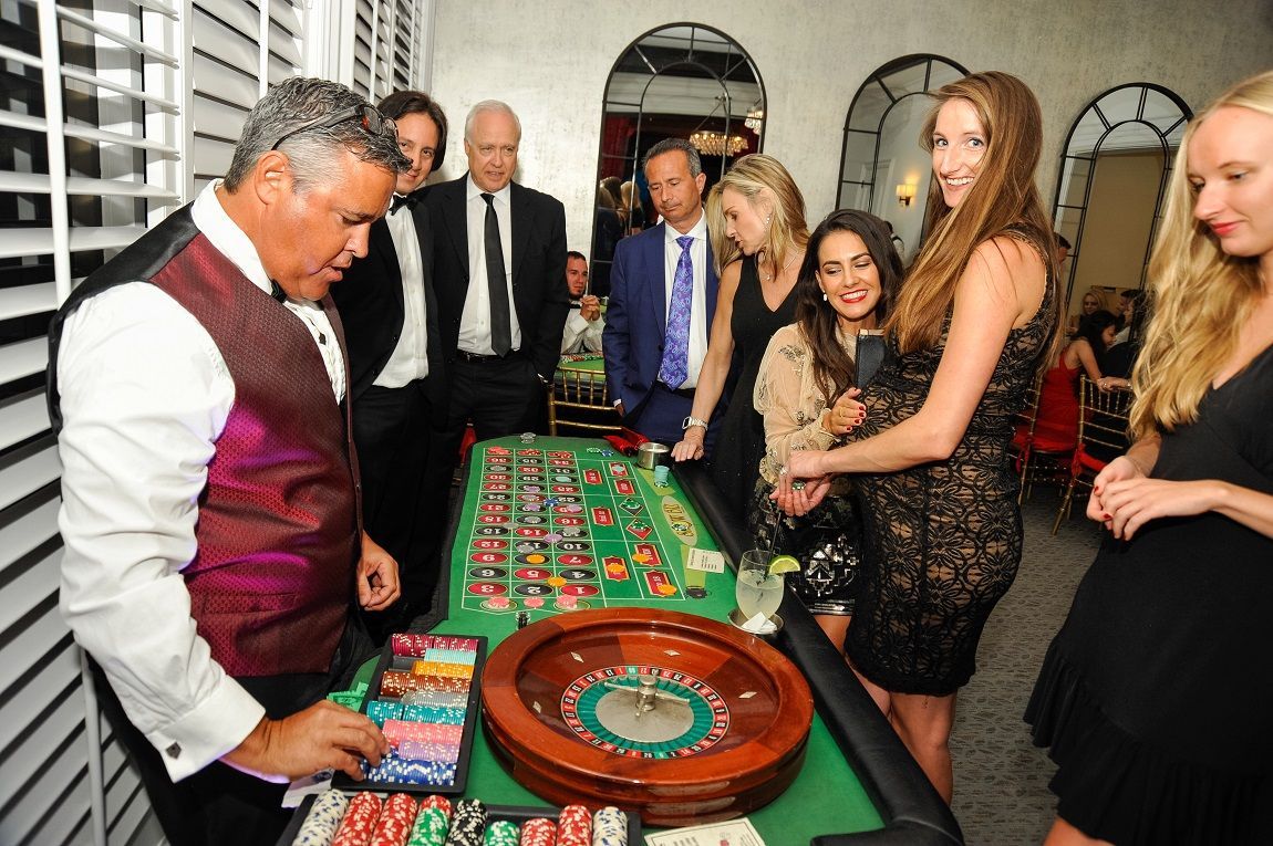Guests enjoying a roulette game at a Casino party.