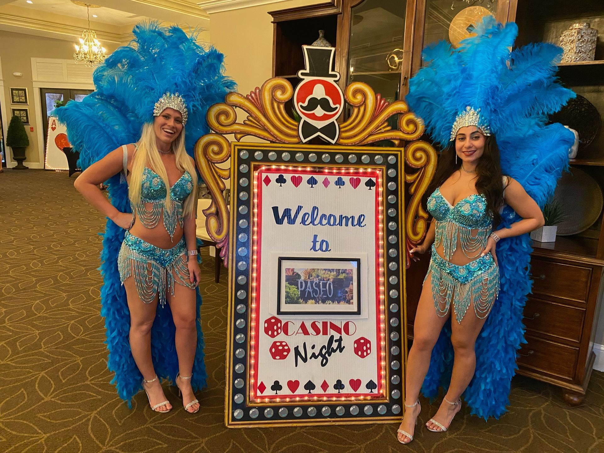 Showgirls standing with welcome casino pro.