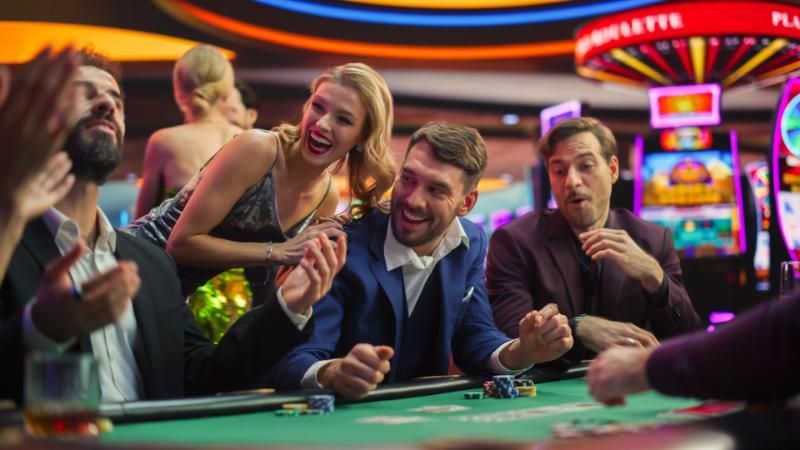A group of people are playing roulette in a casino.