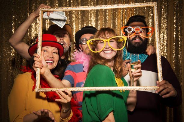 A group of people are posing for a picture in a photo booth.