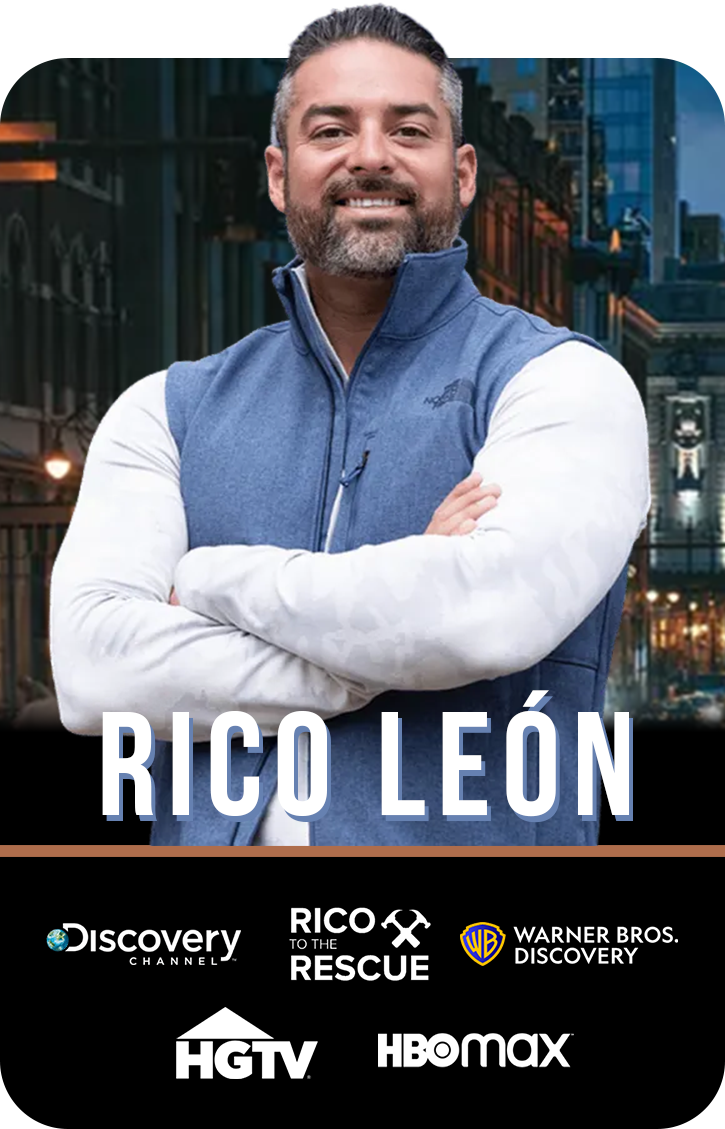 Rico with his arms crossed is wearing a blue vest .