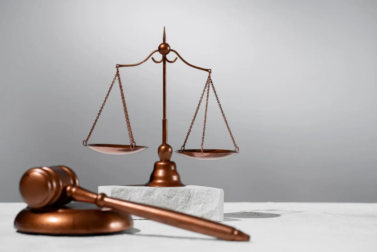 A judge 's gavel and scales of justice are on a table.
