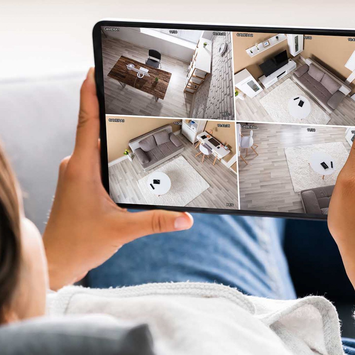 Woman checking the house through the security camera