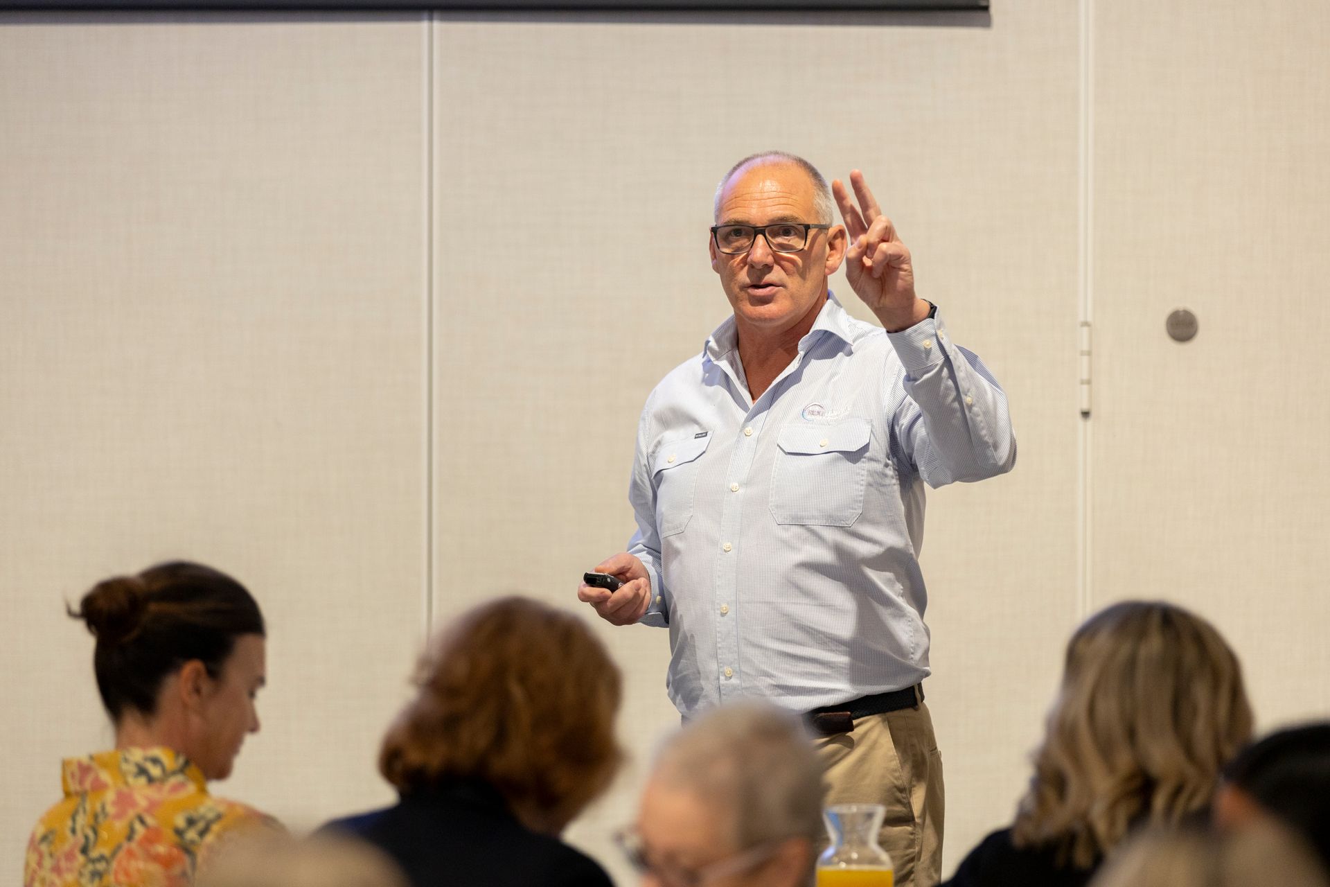 A man is giving a presentation in front of a group of people.