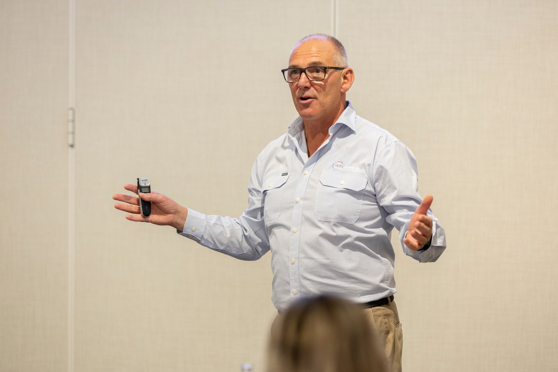 A man is giving a presentation in front of a group of people.