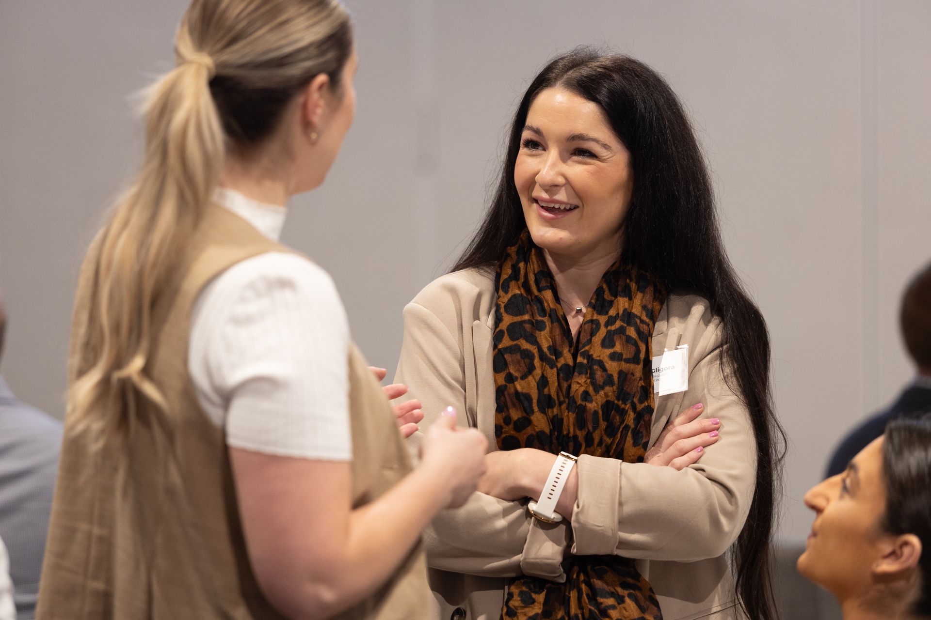 A group of women are talking to each other in a room.